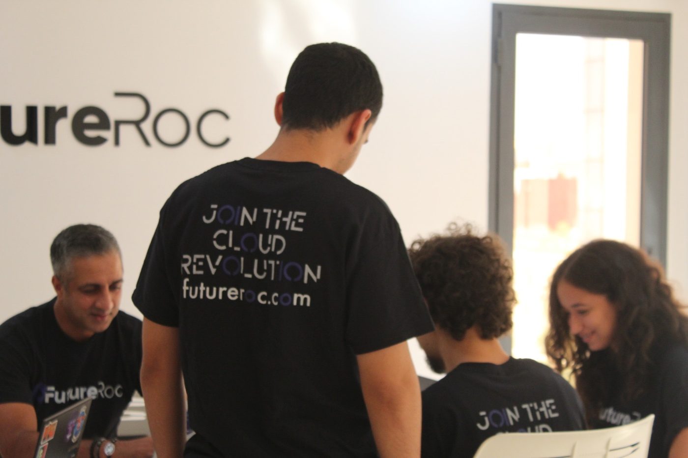 A FutureRoc team member wearing a t-shirt reading Join the Cloud Revolution, futureroc.com